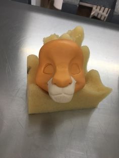 an orange and white plastic animal head sitting on top of a table