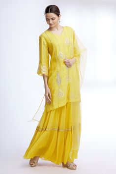 Yellow kurta with floral embroidered motifs and stripes detail. Paired with sharara and sheer dupatta.
Components: 3
Fabric: Pure Silk Chanderi, Chiffon, Organza
Neckline: V neck
Sleeve Length: Three quarter
Color: Yellow
Embroidered
Floral motif work
Sheer dupatta
Tiered sharara
Bead and pearl work
Flared sleeves - Aza Fashions Designer Eid Sharara With Sheer Dupatta, Straight Kurta Sharara With Resham Embroidery For Navratri, Navratri Straight Kurta Sharara With Resham Embroidery, Chikankari Lehenga With Straight Kurta For Diwali, Georgette Sharara With Sheer Dupatta For Diwali, Diwali Lehenga With Chikankari Embroidery And Straight Kurta, Navratri Sharara With Sheer Dupatta In Georgette, Navratri Resham Embroidery Sharara With Straight Kurta, Georgette Straight Kurta Set With Gota Work