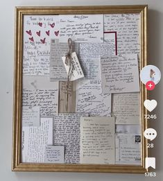 a collage of letters and hearts is hanging on the wall with a gold frame