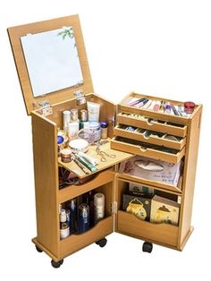 an open wooden vanity with drawers and makeup products on it's sides, in front of a white background