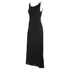 This simple sheer black Dolce & Gabbana sleeveless gown features a column cut with a lightly flared skirt and is complete with interlocking accents at the top of each shoulder. Approximate measurements: Size - removed Bust: 32 - 34" Waist: 28" Hips: 38 - 40" Shoulder to hem: 60" Material tag removed Satin Evening Dresses, Sleeveless Gown, Stretch Satin, Flared Skirt, Black Sleeveless, Dolce & Gabbana, Black Stretch, Flare Skirt, Evening Gown