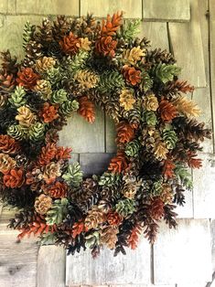 a wreath made out of pine cones and leaves