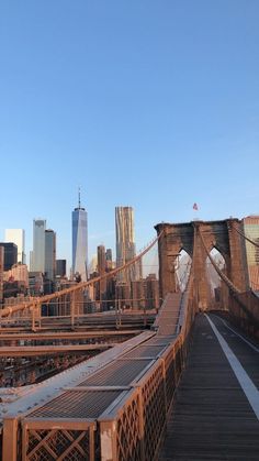 the bridge is very long and has no cars on it, but there are many buildings in the background