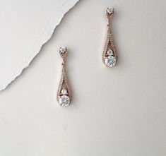 "Simple long dangle rose gold bridal earrings in a lovely tapered teardrop design. Created in rose gold finish with Swarovski Pure brilliance cz stones Earrings measure 1-3/8\" I have a matching necklace for these here: https://www.etsy.com/listing/676227524/rose-gold-backdrop-necklace-bridal-back?ref=shop_home_active_1&frs=1 Matching bracelets: https://www.etsy.com/listing/470895593/rose-gold-bridal-bracelet-dainty-bridal?ref=shop_home_active_4&pro=1&frs=1 https://www.etsy.com/listi Elegant Rose Gold Teardrop Earrings For Wedding, Elegant Rose Gold Teardrop Earrings For Anniversary, Rose Gold Drop Bridal Earrings For Formal Occasions, Elegant Rose Gold Teardrop Bridal Earrings, Formal Rose Gold Drop Bridal Earrings, Rose Gold Bridal Drop Earrings With Elegant Design, Rose Gold Teardrop Wedding Earrings, Formal Rose Gold Bridal Drop Earrings, Rose Gold Dangle Chandelier Earrings For Formal Events