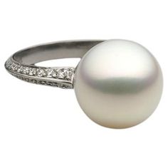 A BUNDA 'Tanara' Pearl and Diamond Ring set in Platinum, Signed BUNDA. Size M. Characteristics of White South Sea Cultured Pearl; 12mm. Characteristics of Additional Round Brilliant Cut Diamonds: 56 = .69ct, F colour, VS Clarity Weight 5.7grams Bezel Set Diamond Ring, South Sea Pearls Earrings, Diamond Ring Set, Pearl And Diamond Ring, Round Diamond Ring, Gold Cocktail Ring, Pearl And Diamond Earrings, Natural Diamond Ring, Diamond Ring Settings