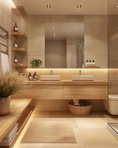 a bathroom with two sinks and a large mirror above the sink is illuminated by recessed lights