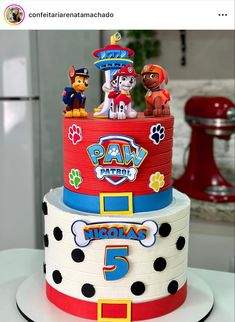 a birthday cake with paw patrol characters on top