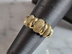 A WOMENS VINTAGE ESTATE 14K YELLOW GOLD MODERNIST RING THAT WAS MADE BY BEVERLY HILLS GOLD.  THE TOTAL WEIGHT IS 4.1g AND IS A SIZE 6.0. THE WIDTH OF THE RING IS 5/16".  RING IS STAMPED ON THE INSIDE OF THE BAND.  ANY QUESTIONS, PLEASE DON'T HESITATE TO ASK.  THIS WOULD MAKE A GREAT GIFT FOR THAT SOMEONE SPECIAL.  BE SURE TO CHECK OUT SOME OF OUR OTHER GREAT ITEMS UP FOR SALE.  THANK YOU. IF THERE ARE ANY ISSUES PLEASE CONTACT US, WE'RE ALWAYS HAPPY TO TRY TO HELP YOU OUT AS BEST AS WE CAN. Antique Gold Dome Ring Stamped 14k, Classic Gold Dome Ring Collectible, Antique Hallmarked Gold Dome Ring, Antique Gold Diamond Cut Rings, Antique Gold Rings With Diamond Cut, Elegant Yellow Gold Dome Ring For Collectors, Vintage Gold Dome Ring Hallmarked, Vintage Gold Dome Ring With Round Band, Formal Gold Dome Ring Stamped 14k