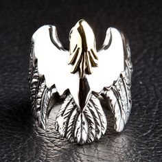 Eagle Hawk 925 Sterling Silver Ring  100% Solid sterling silver  Official.925 trademark stamp on the interior of the band  Polished finish  Measurement of ring face: 1” x 1 1/4” (Inches)   Weight of ring: 20 grams    Get yourself a solid piece of statement rocker jewellery with this Eagle Hawk 925 Sterling Silver Ring.  Revered for its extraordinarily broad wingspan, it’s fully-feathered legs and it’s unmistakable wedge-shaped tail, the eagle-hawk (also known as the wedge-tailed eagle) is the la Silver Bird Ring, Wings Feathers, Rocker Jewelry, Army Rings, Biker Rings Mens, Bird Ring, Eagle Ring, Golden Design, Silver Bird