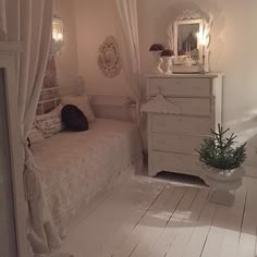 a bedroom with white walls and flooring has a bed, dresser, and mirror