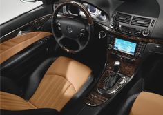 the interior of a car with tan leather and black trims, including steering wheel