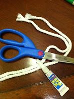 a pair of blue scissors sitting on top of a wooden table