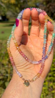 This 24" necklace is the sweetest confection of muted candy colored gemstones. Gems include Strawberry Quartz, Citrine, Amethyst, Scapolite (AKA Lavender Quartz), Lemon Quartz, Chalcedony, Chrysoprase, Tanzanite, Amethyst, Apatite, Aquamarine, Rose Quartz, Heliodor, and some particularly scrumptious Rhodochrosite. It's knotted onto a hand dyed silk cord in a delicate shade of peach and finished with 14/20 gold filled signature cord ends paired with 6mm open loops and heart shaped interchangeable lobster clasp. Lavender Quartz, Knotted Necklace, Shades Of Peach, Colored Gemstones, Rainbow Gemstones, Rainbow Jewelry, Cord Ends, Dyed Silk, Hand Dyed Silk