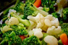 broccoli, cauliflower and carrots are mixed together in a bowl