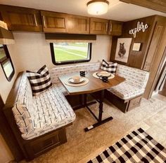 the interior of an rv with two couches and a table