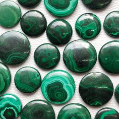 green and black glass buttons with swirls on them, all in the same pattern