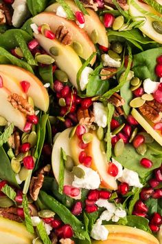 a salad with pears, goat cheese and pomegranate is shown close up