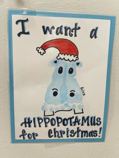 i want a hippopotamus for christmas sign hanging on the wall in front of a refrigerator