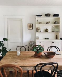 a dining room table with chairs around it