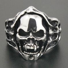 Some think that jewelry must be shiny and soft looking, but you are a wild ! you can't agree with those people, I'm sure this horror savage skull ring is made for you. This ain’t no cheap metal rings like the other, it is a unique piece of jewelry, that only the bravest and the strongest are worth wearing this gorgeous ring. As you may have noticed, it is painted in two different colors, the main color used is silver here to make this jewel look unique and shiny, the second color is black presen Grunge Style Rings For Halloween Gift, Silver Grunge Rings For Halloween, Punk Style Skull Ring For Halloween Collectible, Gothic Skull Ring In Stainless Steel For Halloween, Punk Stainless Steel Rings For Halloween, Collectible Skull Ring For Halloween, Collectible Skull Rings For Halloween, Halloween Skull Print Rings, Unique Halloween Collectible Skull Ring