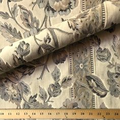 a ruler is next to a fabric with flowers on it