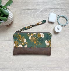 "Green mushroom floral wristlet with faux leather. This small purse is perfect to carry all your essentials for a night out or shopping with the girls. It is also great to add to your diaper bag, tote bag or beach bag to contain your money and cards. It is so versatile and is made with quality materials to last.  This makes a great teacher gift, bridesmaid gifts, birthday gift or just great for yourself! It measures 9\" W and 6\" tall. It is made with green mushroom floral fabric and beautiful b Faux Leather Wristlet, Green Mushroom, Summer Clutch, Diaper Bag Tote, Great Teacher Gifts, Wristlet Purse, Gifts Birthday, Small Purse, Leather Wristlet