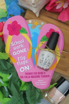 two flip flops with nail polish on them next to some flowers and other items