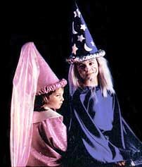 two people dressed up as witches and one is wearing a pink dress with stars on it