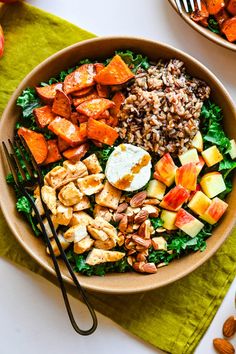 two bowls filled with different types of food on top of a green napkin next to silverware