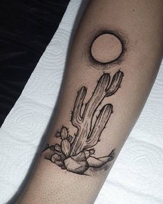 a black and white photo of a cactus tattoo