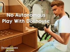 a man sitting on top of a wooden shelf next to a wall with words that read, no autonomous play with dollhouse