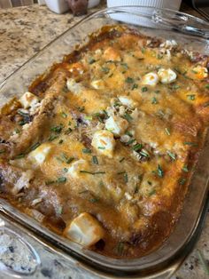 a casserole dish with meat and cheese in it sitting on a counter top