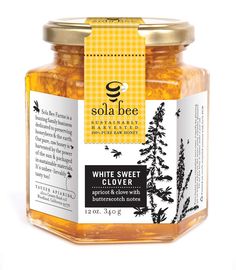 a jar of yellow star thistle honey on a white background with the label below it