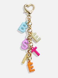 a key chain with the word love spelled in multicolored letters and hearts on it