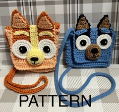 two crocheted purses sitting on top of a table