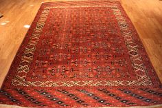 an old red rug is on the floor