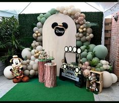 the entrance to mickey mouse's birthday party is decorated with balloons and other decorations