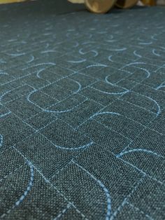 a close up view of a bed with blue fabric