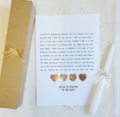 a card with three hearts on it next to a pen and paper gift wrapper