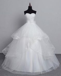 a white wedding dress on a mannequin with a black top and bottom layer