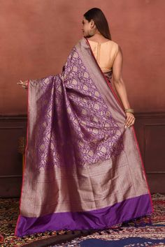 Radiate elegance on festive occasions in this beautiful purple Katan silk Banarasi saree with zari work. The saree has a pink edging. It comes with a matching blouse piece. Disclaimer: The shown stitched blouse on the model is for display purpose only. The saree comes with a matching blouse piece and finished with fall and piko. Disclaimer: The actual product may vary slightly from the image. These are custom orders, hence expect slight variation in color, placement of the motif or buta. ESTIMAT Purple Banarasi Silk Traditional Wear With Pallu, Purple Banarasi Silk Traditional Wear For Puja, Purple Katan Silk Traditional Wear For Diwali, Diwali Purple Katan Silk Traditional Wear, Purple Paithani Silk Saree With Zari Weaving, Purple Banarasi Silk Traditional Wear, Purple Paithani Silk Saree In Traditional Drape, Festive Purple Banarasi Silk Traditional Wear, Purple Anarkali Traditional Handloom Wear