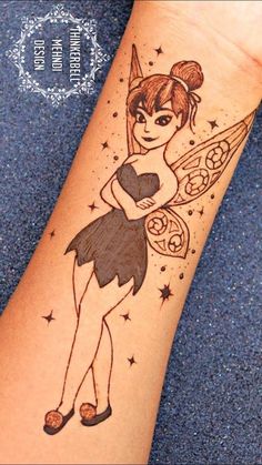 a woman's arm with a tattoo on it that has a fairy tinker