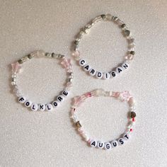 two bracelets with words and beads on them