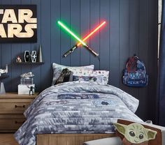 a star wars themed bedroom with lights on the wall and bed in front of it