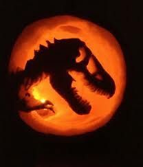 a dragon carved into a pumpkin in the dark