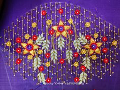 a close up of a purple cloth with gold and red flowers on the back of it