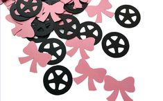 pink and black paper cutouts with bows and peace signs in the shape of hearts