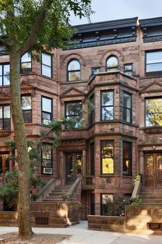 an old brick building with many windows and stairs