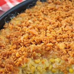 a casserole dish with corn and crumbs on top