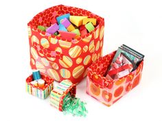 a red bag filled with lots of different types of candy and candies next to each other